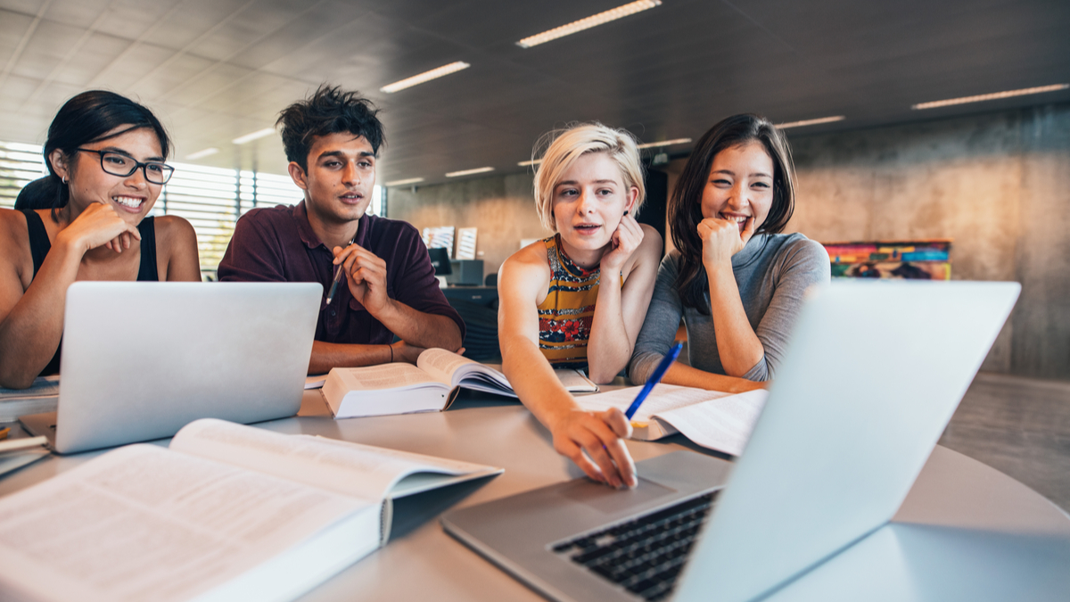 a-group-of-students-sitting-around-a-table-top-programs-to-study-in-canada-for-international-students